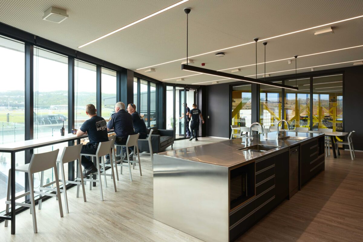 Wellington Airport Fire Station features a range of luminaires from Moth Light, including the up/down light Bob Each Way 65 over the kitchen island.